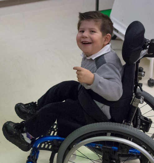 smiling child in wheelchair 